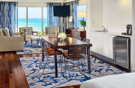 Sonesta Fort Lauderdale Beach gay-friendly hotel suite. Ocean view, dining table, and kitchenette. Perfect for gay travelers.