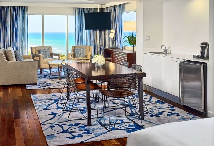 Sonesta Fort Lauderdale Beach gay-friendly hotel suite. Ocean view, dining table, and kitchenette. Perfect for gay travelers.