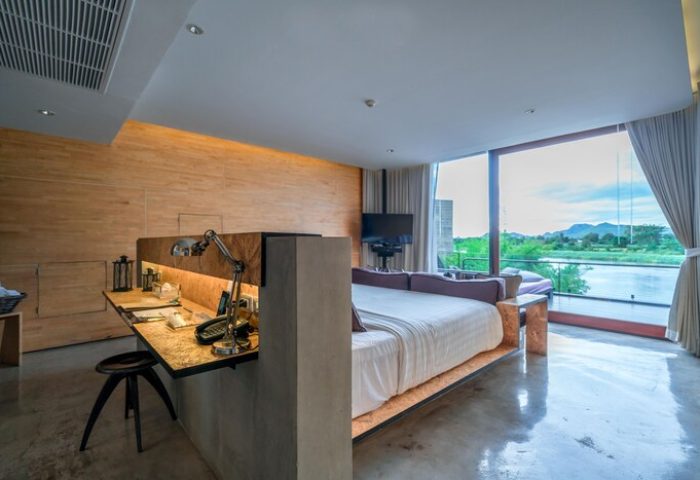 Cross River Kwai gay-friendly hotel room. Modern design with river view. Desk, stool, and bed. Ideal for gay travel. X2 River Kwai stay.