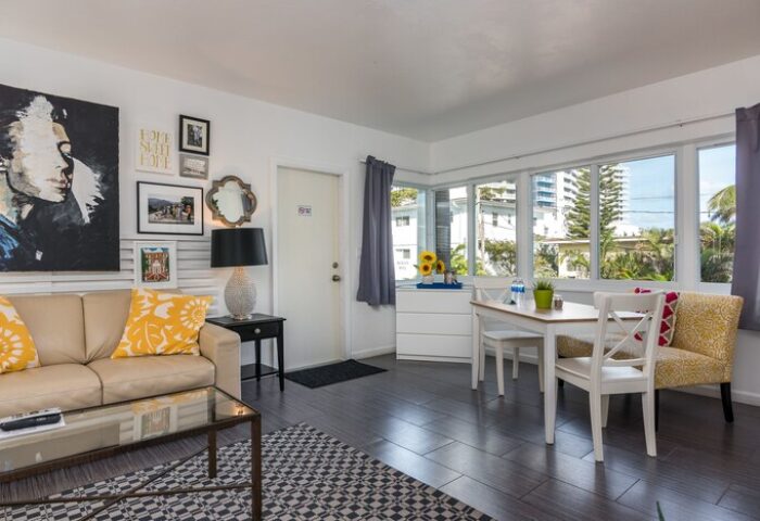 Nobleton Hotel gay-friendly hotel room. Living area with sofa, dining table and chairs. Modern decor. Great for gay travel.