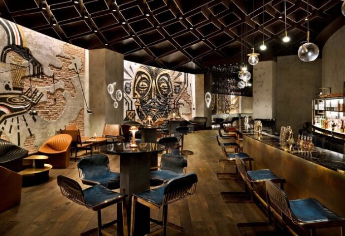 Hotel Indigo Dubai Downtown bar interior. Gay-friendly hotel with artful design, modern seating, and a stylish bar area. Perfect for gay travelers.