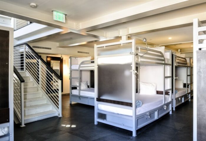 Posh South Beach gay-friendly hotel room. Bunk beds with stairs. Modern hostel interior for gay men. Travel advice for gay travelers.