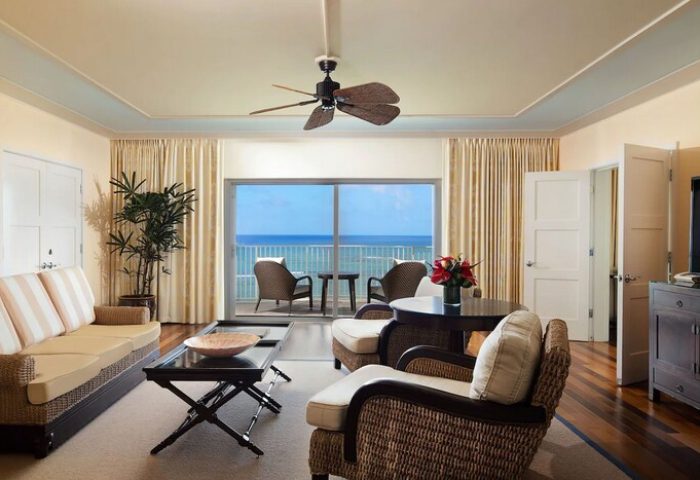 Kahala Hotel and Resort gay-friendly suite. Ocean view from the balcony, wicker furniture, ceiling fan. Luxury travel for gay men.