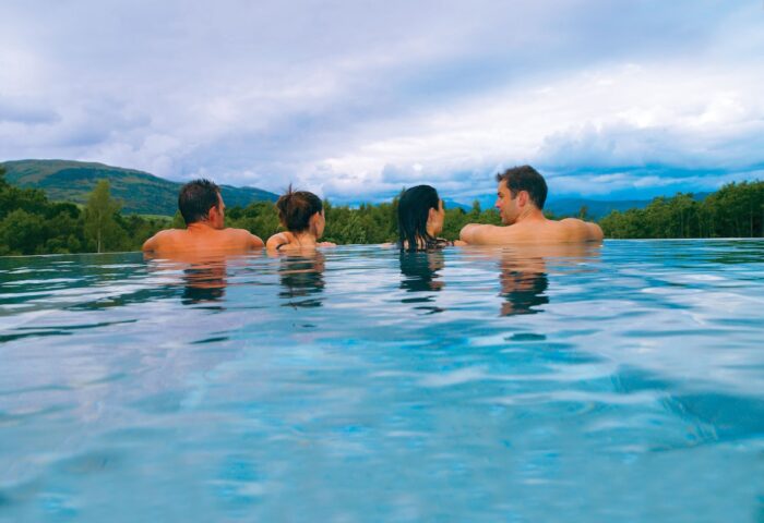 Cameron House on Loch Lomond: People relax in a pool at this gay-friendly hotel, enjoying views of the Scottish Highlands.