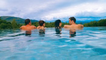 Cameron House on Loch Lomond: People relax in a pool at this gay-friendly hotel, enjoying views of the Scottish Highlands.