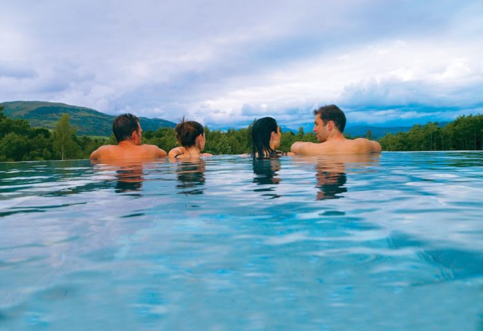 Cameron House on Loch Lomond: People relax in a pool at this gay-friendly hotel, enjoying views of the Scottish Highlands.