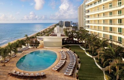 The Ritz-Carlton, Fort Lauderdale: Gay-friendly hotel with pool, ocean view, palm trees, and beach. Perfect for gay men's travel and relaxation.
