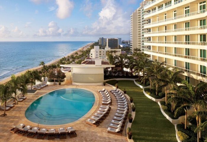 The Ritz-Carlton, Fort Lauderdale: Gay-friendly hotel with pool, ocean view, palm trees, and beach. Perfect for gay men's travel and relaxation.