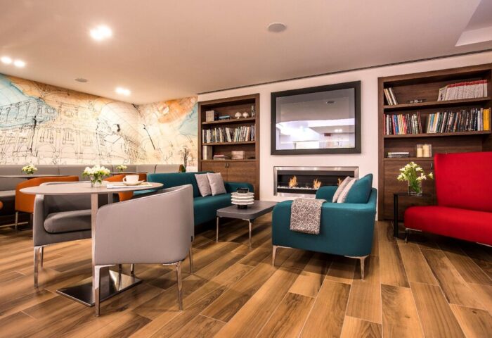 43 Station Hotel's stylish lounge with sofas, chairs, fireplace, and bookshelves. A gay-friendly hotel offering a comfortable stay.