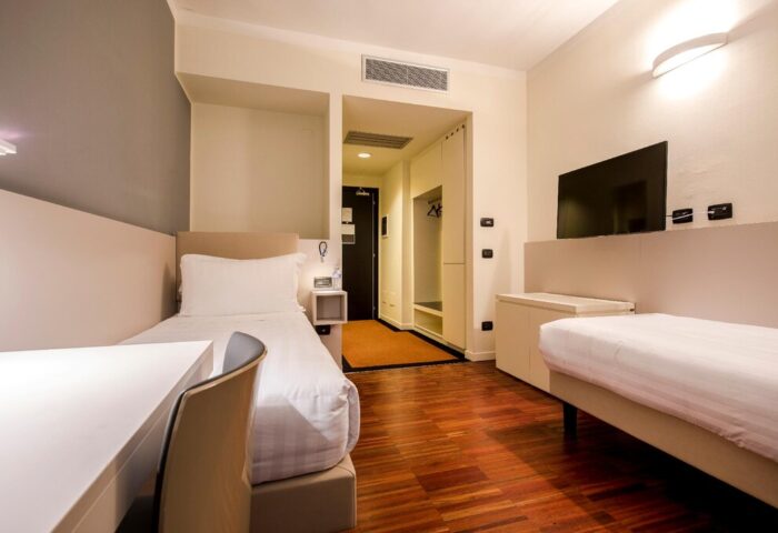 43 Station Hotel room. Gay-friendly hotel with two single beds, desk, TV, and closet. Modern design, comfortable for gay travelers.