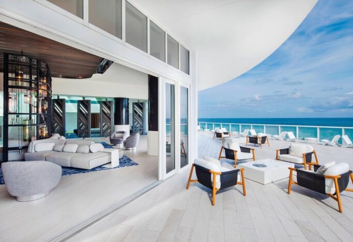W Fort Lauderdale gay-friendly hotel. Ocean view from a luxury suite's balcony with modern outdoor furniture. Ideal for gay travelers.