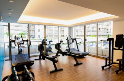 Gym at OUTRIGGER Reef Waikiki Beach Resort, a gay-friendly hotel. Fitness equipment includes treadmills, rowing machines, & weights.