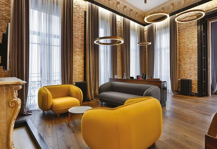 Hotel The Public Special Category room. Gay-friendly hotel interior with exposed brick, modern lighting, and stylish furniture. Travel advice.