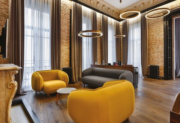Hotel The Public Special Category room. Gay-friendly hotel interior with exposed brick, modern lighting, and stylish furniture. Travel advice.