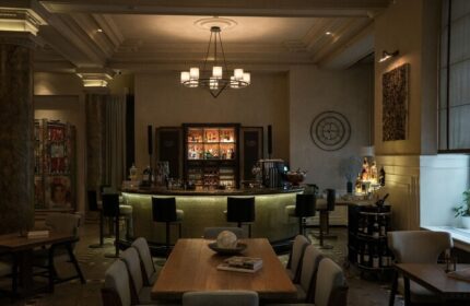 The Bank Hotel Istanbul bar area. Gay-friendly hotel interior with bar, tables, and chairs. Design Hotels™ member, stylish decor.