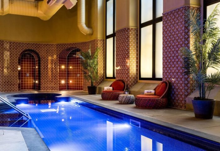 St. Pancras Renaissance Hotel London indoor pool. Gay-friendly hotel with relaxing lounge chairs and stylish tile work, a great place to unwind.