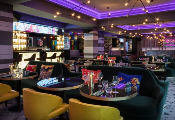 NYX Hotel London Holborn's stylish bar area. Gay-friendly hotel with modern decor, plush seating, and a vibrant atmosphere. Perfect for gay travelers.