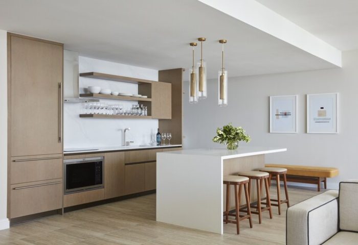 Four Seasons Hotel and Residences Fort Lauderdale gay-friendly hotel kitchen. Modern design with island, stools, and open shelving.