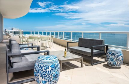 The Ritz-Carlton, Fort Lauderdale gay-friendly hotel balcony view. Outdoor seating, ocean view, and blue accents. Perfect for gay travelers.
