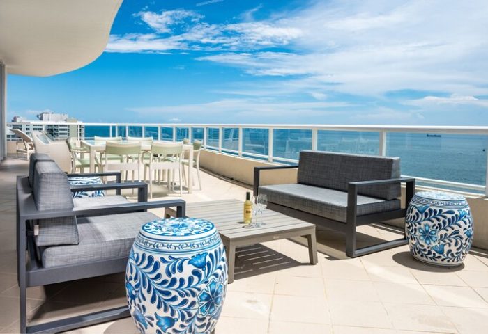 The Ritz-Carlton, Fort Lauderdale gay-friendly hotel balcony view. Outdoor seating, ocean view, and blue accents. Perfect for gay travelers.