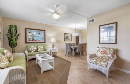 Coconut Bay Resort gay-friendly hotel room. Wicker furniture, floral cushions, dining table. Tropical decor for gay men travel.