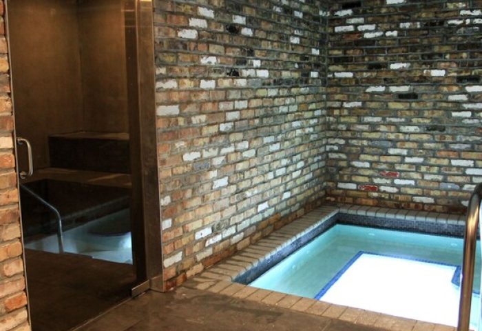 Gaythering Hotel's gay-friendly spa. All-adults welcome. Brick walls surround a small, tiled hot tub and sauna area for relaxation.