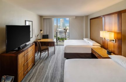 Hyatt Regency Miami gay-friendly hotel room. Two beds, desk, TV, and city view. Comfortable accommodations for gay travelers.
