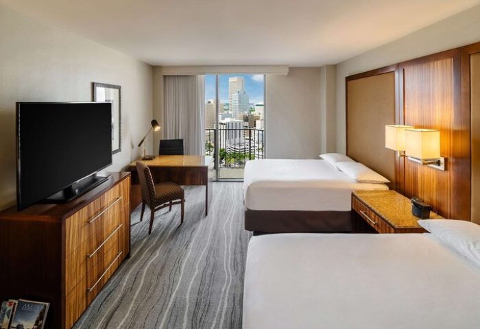 Hyatt Regency Miami gay-friendly hotel room. Two beds, desk, TV, and city view. Comfortable accommodations for gay travelers.