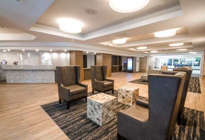 Comfort Inn & Suites Downtown Brickell-Port of Miami lobby seating area. Gay-friendly hotel with modern decor, comfortable chairs, and reception desk.