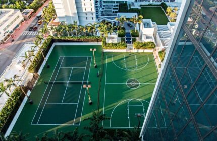 Aerial view of W South Beach gay-friendly hotel featuring tennis and basketball courts. A luxury travel destination for gay men.