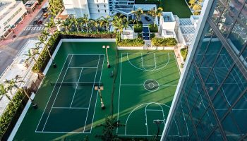 Aerial view of W South Beach gay-friendly hotel featuring tennis and basketball courts. A luxury travel destination for gay men.