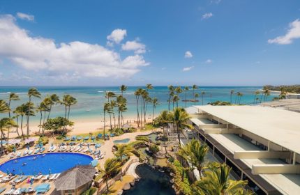 Kahala Hotel and Resort aerial view. Gay-friendly hotel with pool, beach, and palm trees. Ideal for gay men's travel in Honolulu.
