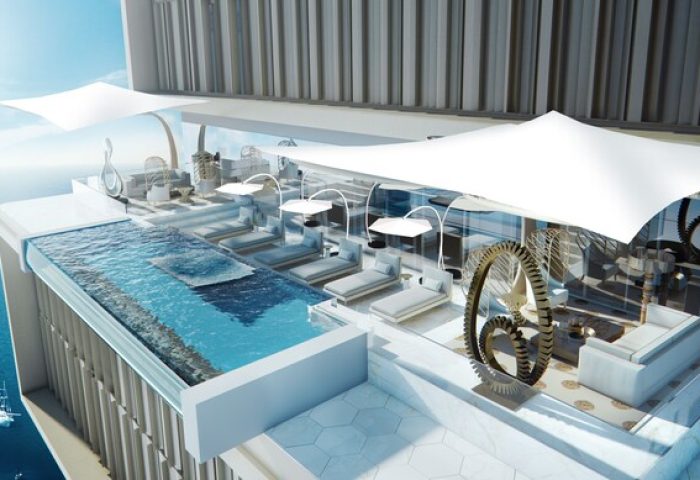 Atlantis The Royal gay-friendly hotel: rooftop pool, lounge chairs, and ocean view. Luxury travel for gay men. Modern design, relaxing vacation.