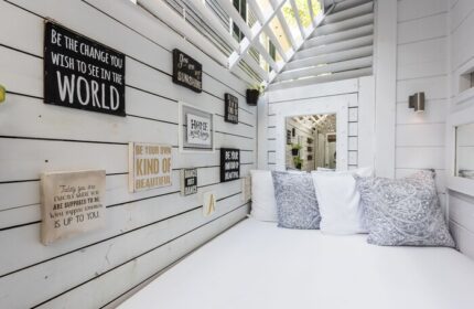 Alexander's Guesthouse gay-friendly hotel: Stylish white daybed with pillows and inspirational wall art. A relaxing space for gay travelers.