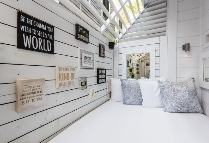 Alexander's Guesthouse gay-friendly hotel: Stylish white daybed with pillows and inspirational wall art. A relaxing space for gay travelers.
