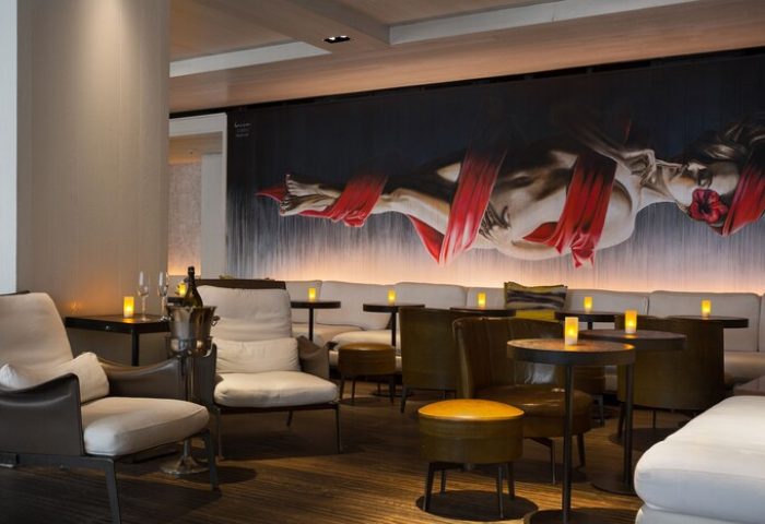The Modern Honolulu, a gay-friendly hotel. Lounge area with art, seating, and tables. Perfect for gay men's travel advice.