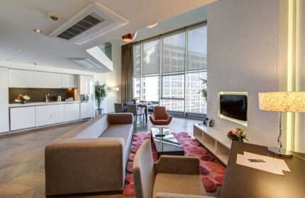 Elysium Taksim Hotel gay-friendly suite: open-plan living area with kitchen, dining, and lounge. Modern design, city view. Ideal for gay travelers.