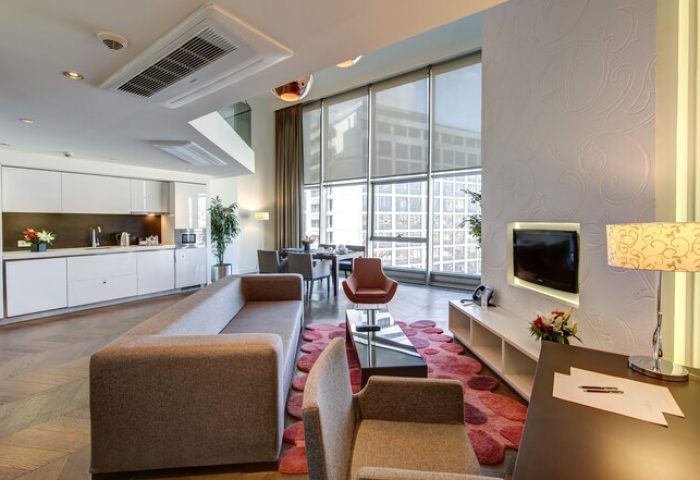 Elysium Taksim Hotel gay-friendly suite: open-plan living area with kitchen, dining, and lounge. Modern design, city view. Ideal for gay travelers.