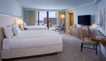 Hyatt Regency Waikiki Beach Resort & Spa gay-friendly hotel room. Two beds, desk, TV, and balcony with ocean view. Perfect for gay travel.