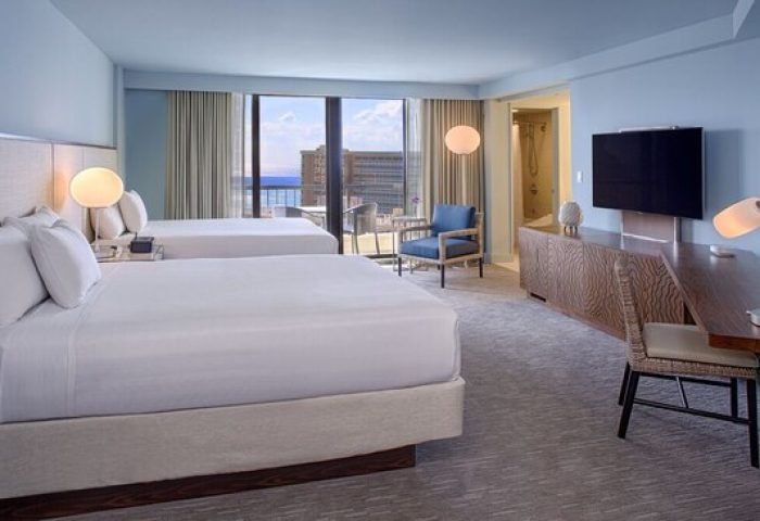 Hyatt Regency Waikiki Beach Resort & Spa gay-friendly hotel room. Two beds, desk, TV, and balcony with ocean view. Perfect for gay travel.