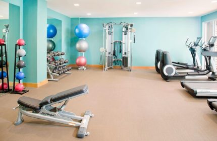 The Laylow Autograph Collection gay-friendly hotel gym with exercise equipment, weights, fitness balls, and treadmills for a workout.