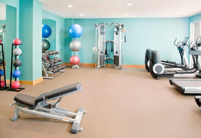 The Laylow Autograph Collection gay-friendly hotel gym with exercise equipment, weights, fitness balls, and treadmills for a workout.