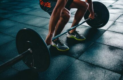 W Dubai - Mina Seyahi gay-friendly hotel gym: Man lifting barbell. Fitness center at this Dubai hotel offers workout equipment.