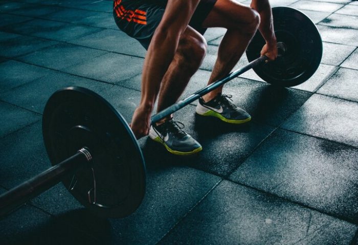 W Dubai - Mina Seyahi gay-friendly hotel gym: Man lifting barbell. Fitness center at this Dubai hotel offers workout equipment.