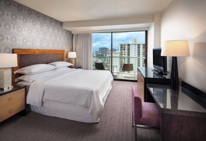Sheraton Princess Kaiulani, gay-friendly hotel room. Balcony view of Honolulu. King bed, desk, and TV. Great for gay men travel in Hawaii.