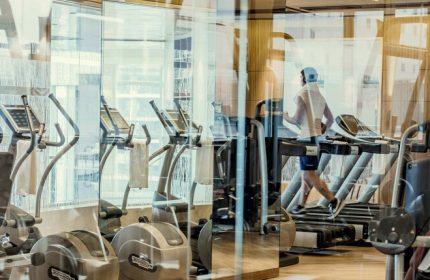 Four Seasons Hotel and Residences Fort Lauderdale gym. Man on treadmill at this gay-friendly hotel. Fitness center with exercise equipment.