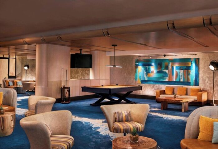 The Ritz-Carlton, Fort Lauderdale gay-friendly hotel: Lounge area with pool table, seating, and colorful artwork. Upscale gay travel experience.