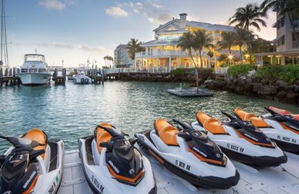 Hyatt Centric Key West Resort: Jet skis at the gay-friendly hotel's marina. Boats docked, palm trees, & resort building in the background.