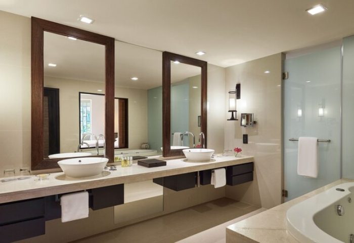 Bathroom at The Barai Hyatt, a gay-friendly hotel. Double vanity with large mirrors, bathtub, and modern design. Ideal for gay travel.