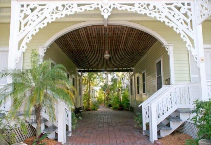 Island City House, a gay-friendly hotel. Covered walkway with tropical plants. Key West gay travel lodging, architecture, and design.